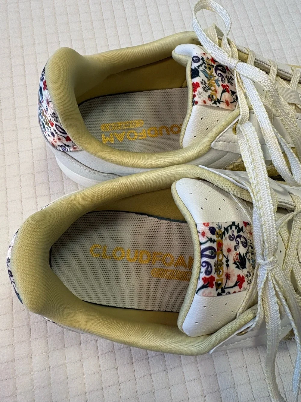 Adidas cream colored sneakers with floral accents